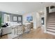 Living room with decorative wall, white sofa, neutral decor, and light hardwood floors at 207 Somerset Acres Dr, Summerville, SC 29486