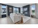 A stylish living room features a fireplace with TV above and large windows with beautiful sunlight at 207 Somerset Acres Dr, Summerville, SC 29486