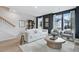 A modern living room with two chairs, a bookshelf, and large windows, perfect for relaxing or entertaining at 207 Somerset Acres Dr, Summerville, SC 29486