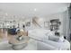 A beautifully designed living room connected to the kitchen with plenty of natural light and stairs at 207 Somerset Acres Dr, Summerville, SC 29486