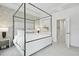 A well-lit main bedroom featuring a four-poster bed, tray ceilings and ensuite bath at 207 Somerset Acres Dr, Summerville, SC 29486