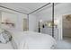 A serene bedroom featuring a four-poster bed, ensuite bath and walk in closet with modern finishes at 207 Somerset Acres Dr, Summerville, SC 29486