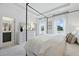 Spacious bedroom with a four poster bed, large window views, and access to the ensuite bathroom at 207 Somerset Acres Dr, Summerville, SC 29486