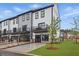 New townhome exteriors featuring a two-car garage, balcony, and accessible parking space at 207 Somerset Acres Dr, Summerville, SC 29486