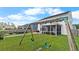 The backyard has a swing set and screened porch, perfect for Gathering fun and relaxation at 211 Squire Pope Rd, Summerville, SC 29486