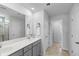 A modern bathroom with a double vanity, neutral color palette, and a frameless glass shower at 211 Squire Pope Rd, Summerville, SC 29486
