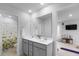 Bright bathroom featuring a double vanity, large mirror, and a shower/tub with floral curtain at 211 Squire Pope Rd, Summerville, SC 29486