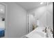 Bathroom with double sinks, white countertops, and an open doorway to a bedroom at 211 Squire Pope Rd, Summerville, SC 29486
