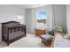 Comfortable Bedroom with a wooden crib and rocking chair beside a window with a view of the lake at 211 Squire Pope Rd, Summerville, SC 29486