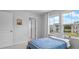 A bedroom showcases abundant light from its large windows, complemented by a simple metal bed frame at 211 Squire Pope Rd, Summerville, SC 29486