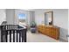 Bright Bedroom with a dark wood crib, rocking chair, and dresser, with an outdoor view from the window at 211 Squire Pope Rd, Summerville, SC 29486