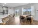 Bright dining area featuring wood floors, a wood dining table, and a large window overlooking the fenced backyard at 211 Squire Pope Rd, Summerville, SC 29486