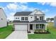 Charming two-story home with brick and white siding, a well-manicured lawn, and a two-car garage at 211 Squire Pope Rd, Summerville, SC 29486