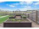 The backyard features raised garden beds with lush plants and a serene pond view at 211 Squire Pope Rd, Summerville, SC 29486