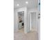 Hallway with entrances to the laundry room, and another room with neutral colored carpet at 211 Squire Pope Rd, Summerville, SC 29486