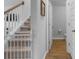 Hallway with a staircase featuring a baby gate, and a view into a half bathroom at 211 Squire Pope Rd, Summerville, SC 29486