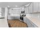 Gourmet kitchen with white cabinets, quartz countertops, stainless steel appliances, and stylish tile backsplash at 211 Squire Pope Rd, Summerville, SC 29486