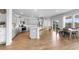 Modern kitchen with gray cabinetry, stainless steel appliances, large island, and dining area filled with natural light at 211 Squire Pope Rd, Summerville, SC 29486