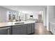 Bright, open kitchen with large island, stainless steel appliances, and seamless flow into the living area at 211 Squire Pope Rd, Summerville, SC 29486