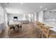 Open-concept living room with wood floors, a kitchen island with barstool seating, and access to the upstairs at 211 Squire Pope Rd, Summerville, SC 29486
