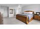 A spacious main bedroom showcasing a wooden bed frame, soft carpet, and relaxing coastal decor at 211 Squire Pope Rd, Summerville, SC 29486