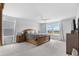 A main bedroom features a wooden bed frame, soft carpeting, and ample natural light at 211 Squire Pope Rd, Summerville, SC 29486