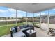 Relaxing screened porch with comfortable seating and a view of the fenced yard and lake at 211 Squire Pope Rd, Summerville, SC 29486