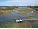 Aerial view of boat dock and marshy landscape with waterway access to the open water at 2128 Breezy Point Dr, Mount Pleasant, SC 29466