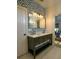 Chic bathroom boasting a double vanity with marble countertop, custom wallpaper, and modern fixtures, perfect for a refined lifestyle at 2128 Breezy Point Dr, Mount Pleasant, SC 29466