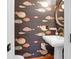 Charming powder room with fish wallpaper, a gold mirror, and a white pedestal sink at 2128 Breezy Point Dr, Mount Pleasant, SC 29466