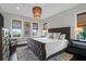 Comfortable bedroom with a tufted headboard, natural light, and hardwood floors at 2128 Breezy Point Dr, Mount Pleasant, SC 29466