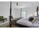 Bright bedroom with a four-poster bed, comfortable chairs, and balcony access at 2128 Breezy Point Dr, Mount Pleasant, SC 29466