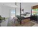 This bedroom features a four-poster bed, ceiling fan, and balcony access with gorgeous views at 2128 Breezy Point Dr, Mount Pleasant, SC 29466