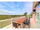 Outdoor deck showcasing scenic views, a dining table, and comfortable seating, perfect for enjoying the beautiful natural surroundings at 2128 Breezy Point Dr, Mount Pleasant, SC 29466