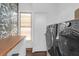 Laundry room with modern appliances, wood countertop, and a window providing natural light at 2128 Breezy Point Dr, Mount Pleasant, SC 29466