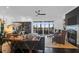 Inviting living room with a fireplace, comfortable seating, and beautiful views of the lush outdoor landscape at 2128 Breezy Point Dr, Mount Pleasant, SC 29466