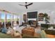 Cozy living room with a fireplace, comfortable chairs, and a screened-in patio with outdoor seating at 2128 Breezy Point Dr, Mount Pleasant, SC 29466