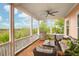 Enjoy the scenic views from the screened porch with comfortable seating and an outdoor grill at 2128 Breezy Point Dr, Mount Pleasant, SC 29466