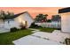 Charming backyard featuring a white picket fence, green grass and overhead string lights at 221 Trillium Ave, Summerville, SC 29483