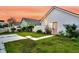 Charming backyard with white picket fence, green grass, concrete pavers, and overhead string lights at 221 Trillium Ave, Summerville, SC 29483