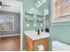 Bathroom with sink, decorative mirror, floating shelves, and nearby bedroom at 221 Trillium Ave, Summerville, SC 29483
