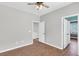A spacious bedroom with wood-look floors, ceiling fan, and ample natural light at 221 Trillium Ave, Summerville, SC 29483