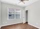 Bright bedroom featuring wood-look flooring, window, and ceiling fan at 221 Trillium Ave, Summerville, SC 29483