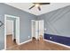 Stylish bedroom with unique accent wall and multiple doors leading to other spaces at 221 Trillium Ave, Summerville, SC 29483