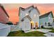 Two-story home with white siding, a charming porch, and a well-maintained yard with a white picket fence at 221 Trillium Ave, Summerville, SC 29483