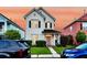 Charming two-story home with black shutters, a pink door, and well-maintained landscaping at 221 Trillium Ave, Summerville, SC 29483