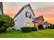 Two-story white home with black shutters, a well-manicured lawn, and a lovely green tree at 221 Trillium Ave, Summerville, SC 29483