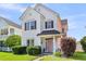 Charming two-story home with black shutters and a pink front door, surrounded by green bushes at 221 Trillium Ave, Summerville, SC 29483