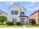 Charming two-story white home with dark shutters, front porch, and manicured landscaping at 221 Trillium Ave, Summerville, SC 29483