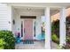 Inviting front porch with a pink door, stylish decor, and a welcoming atmosphere for relaxing and greeting guests at 221 Trillium Ave, Summerville, SC 29483